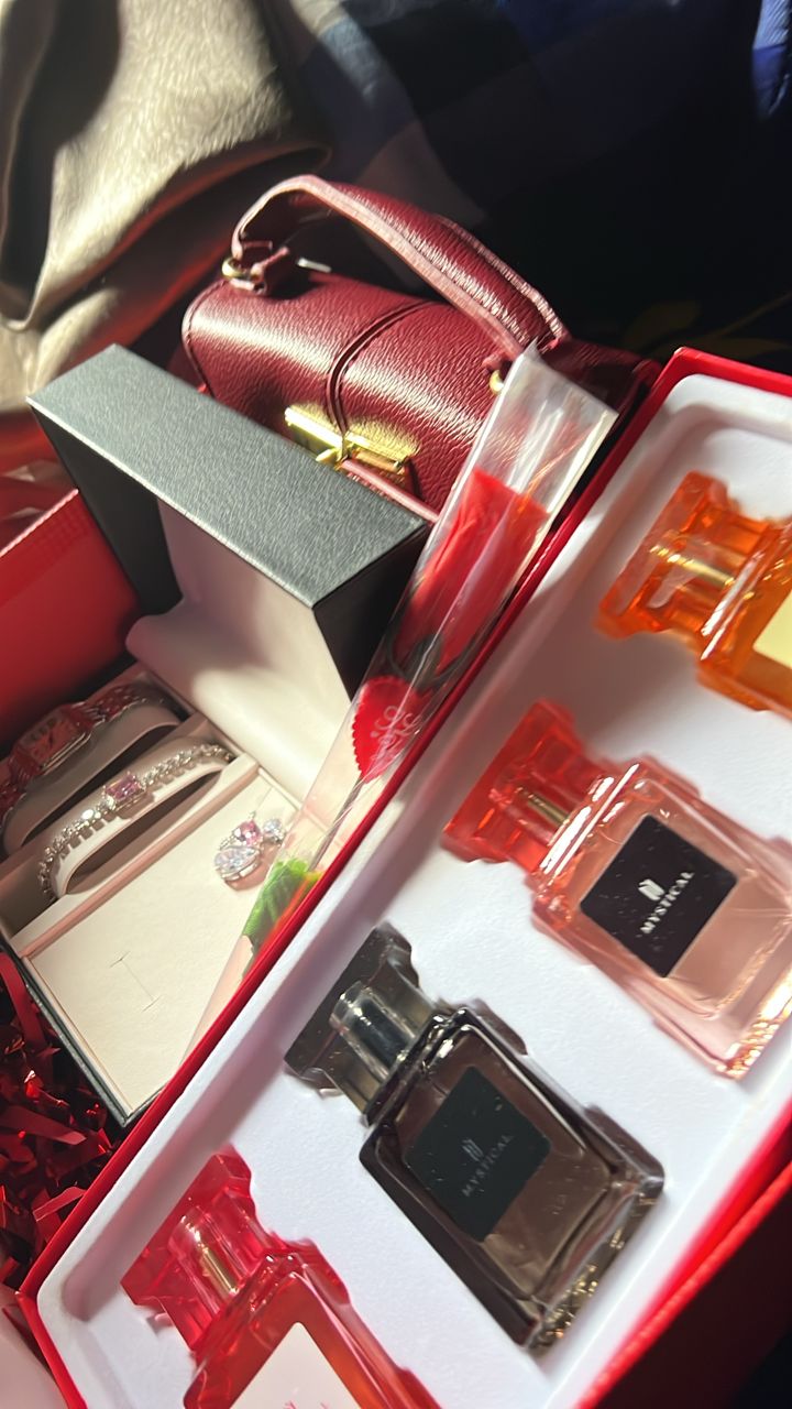 Red luxe gift hamper with perfumes, jewellery and a mini handbag