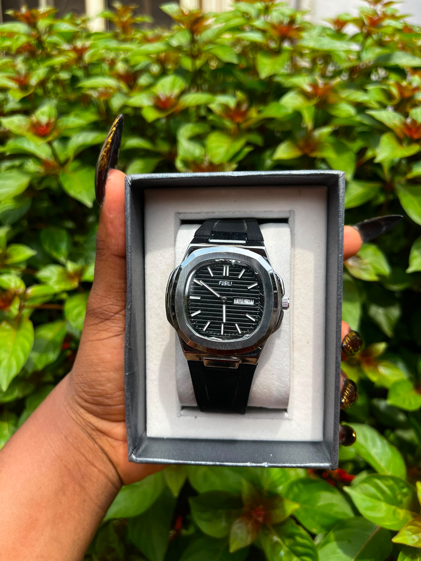 Silver and black wristwatch presented in a grey gift box