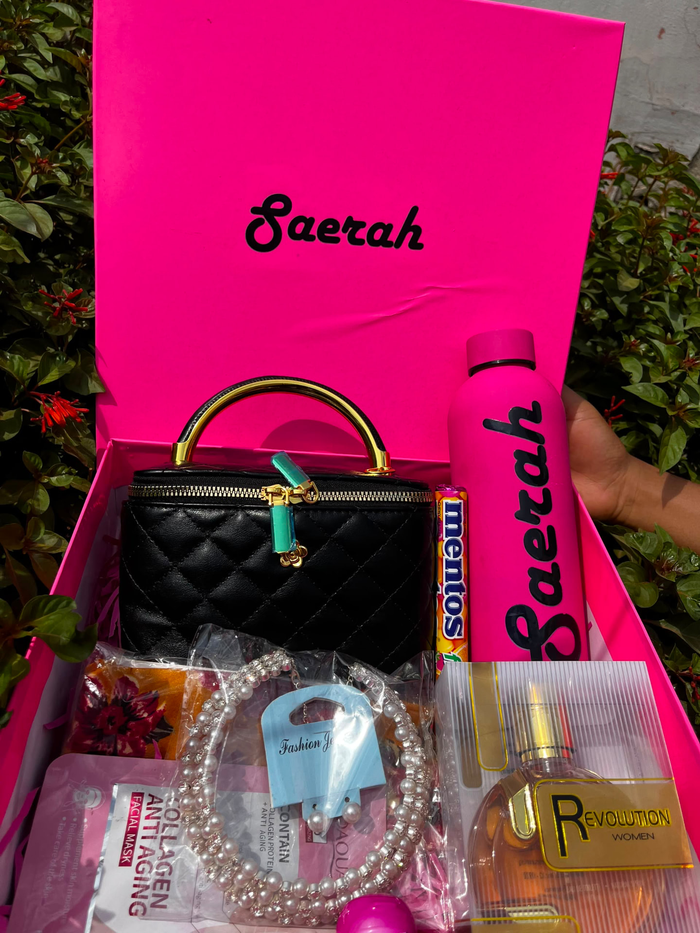 Personalized pink gift box with a quilted handbag, custom name bottle, perfume and jewellery